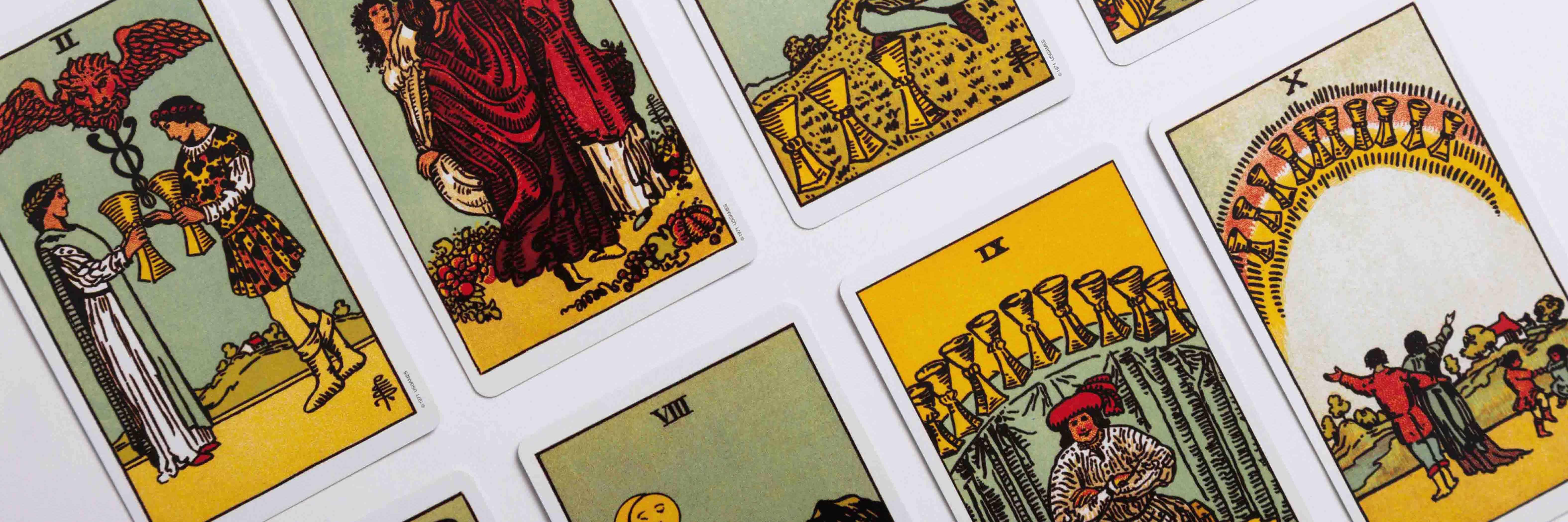 Cup suit cards from the Rider Waite tarot deck in rows, captured in a dutch angle.
