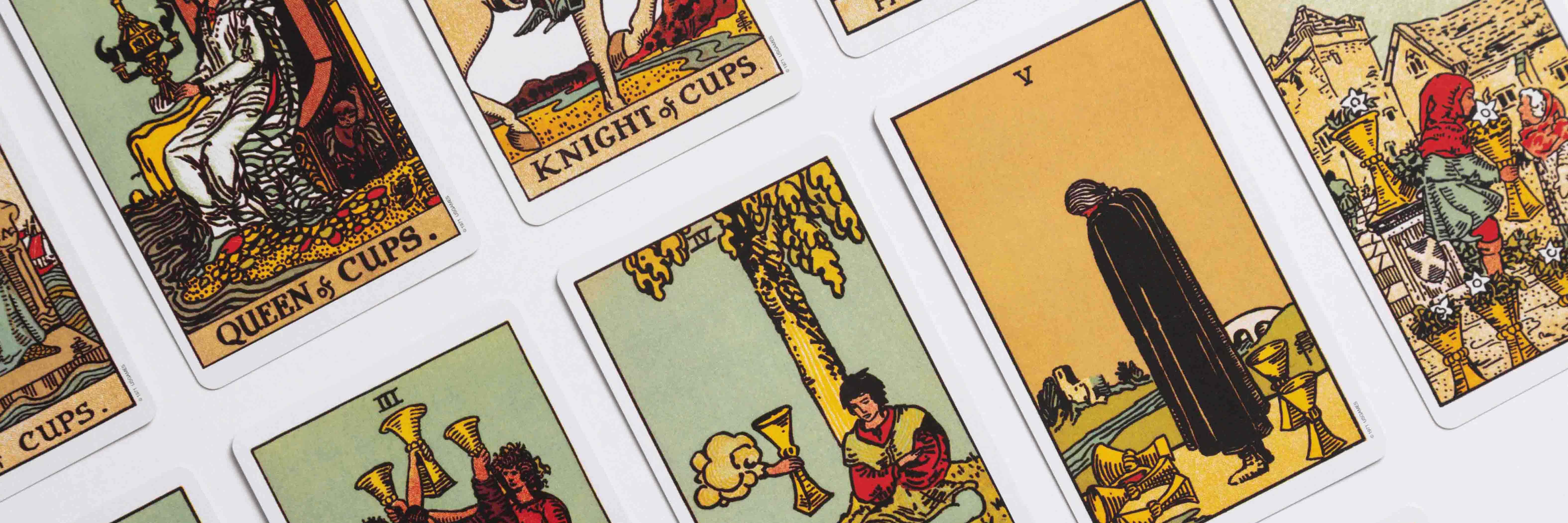 Cup suit cards from the Rider Waite tarot deck in rows, captured in a dutch angle.