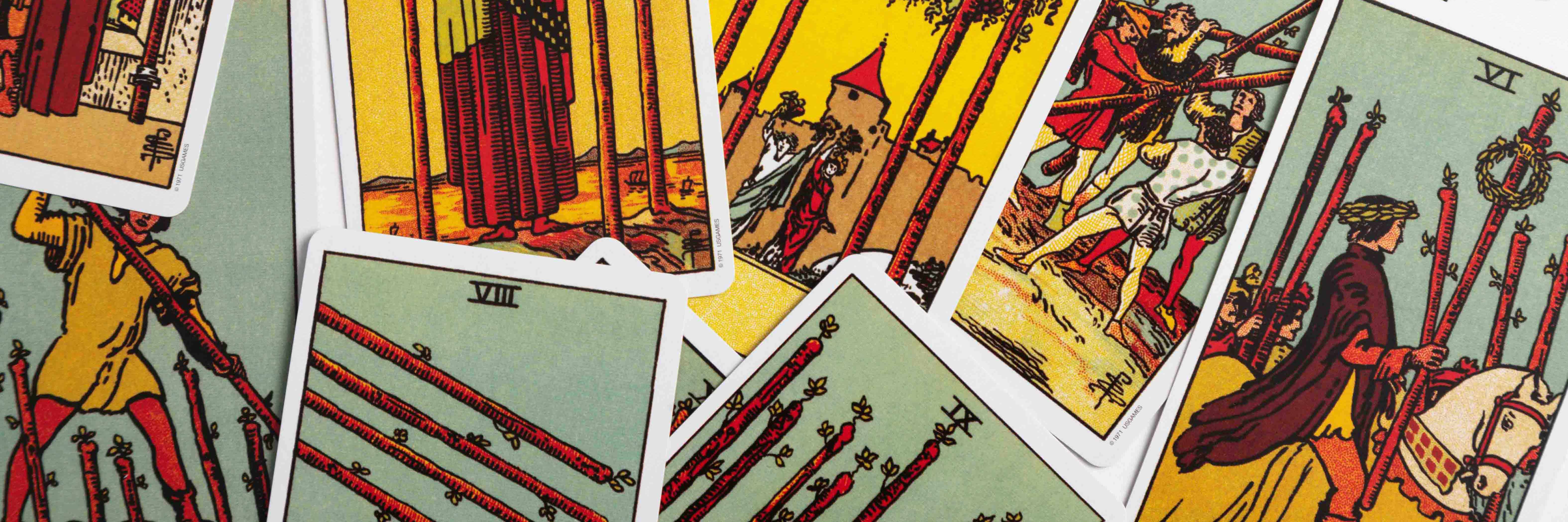 The suit of wands from the Rider Waite tarot deck in a messy layout.
